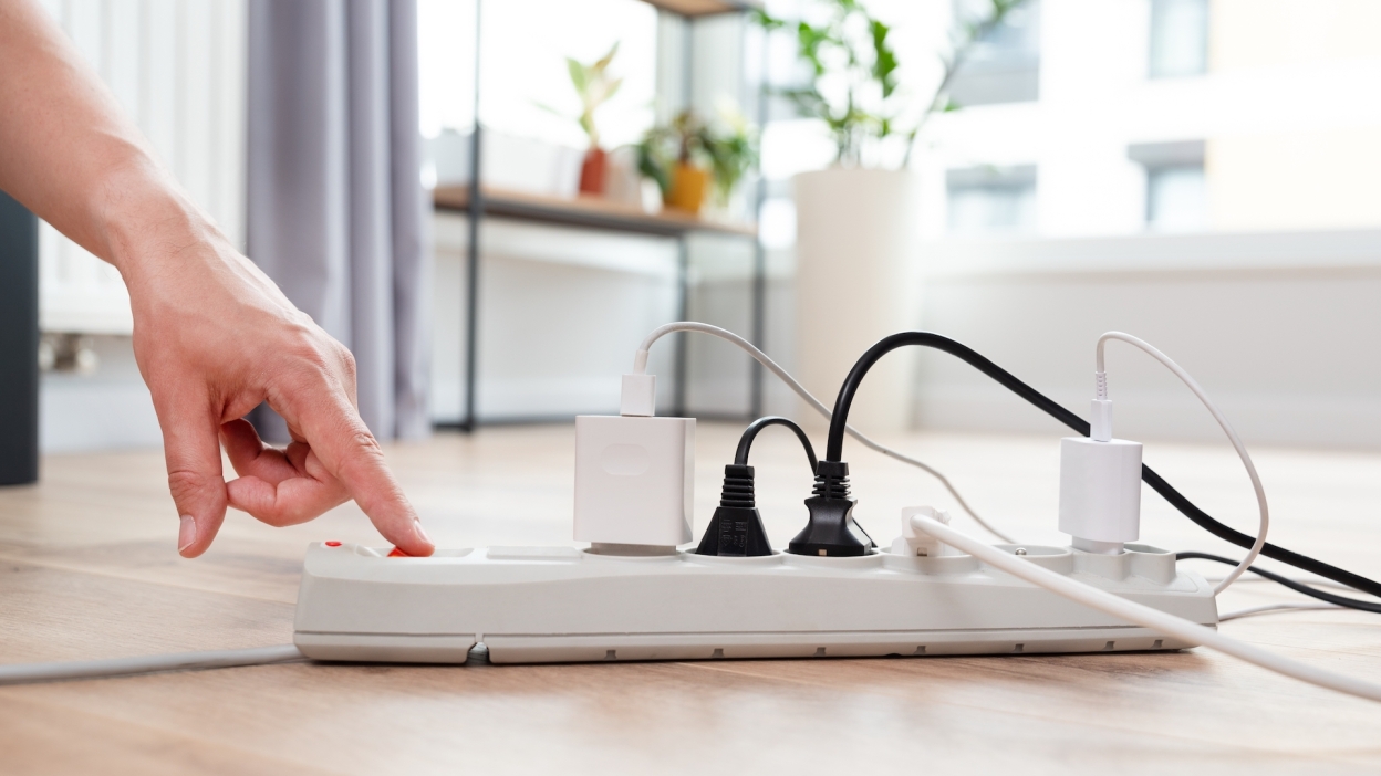 science Person flipping switch on home extension cord