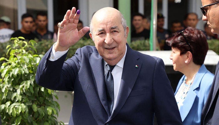 Le président algérien Abdelmadjid Tebboune sort d'un bureau de vote à Alger après avoir voté le 7 septembre 2024.