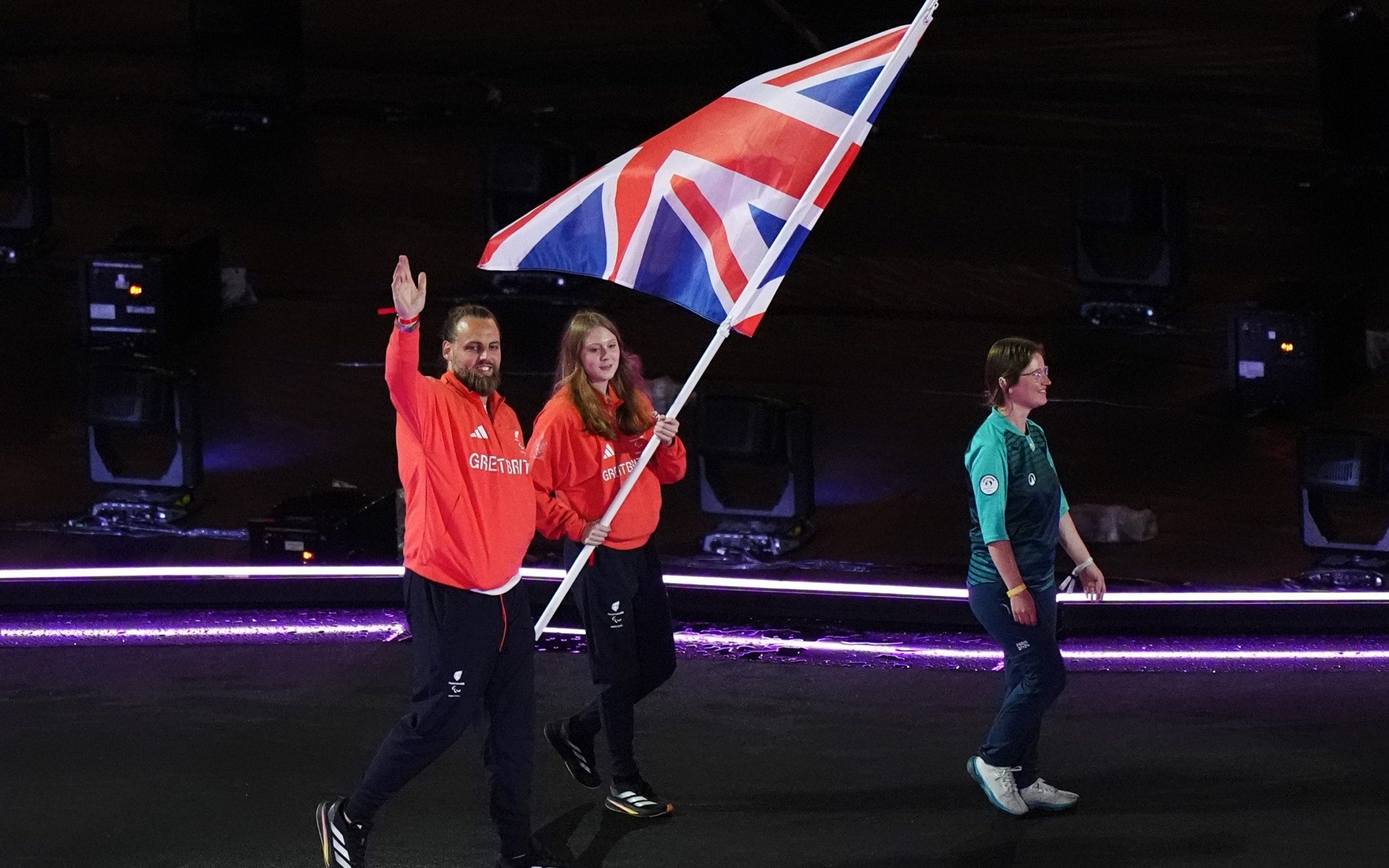 Poppy Maskill and Matt Bush with the flag during the closing ceremony