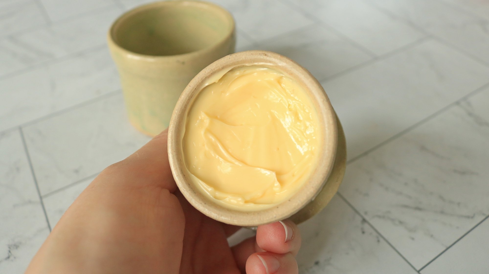 Main tenant lid with butter filling the cup.